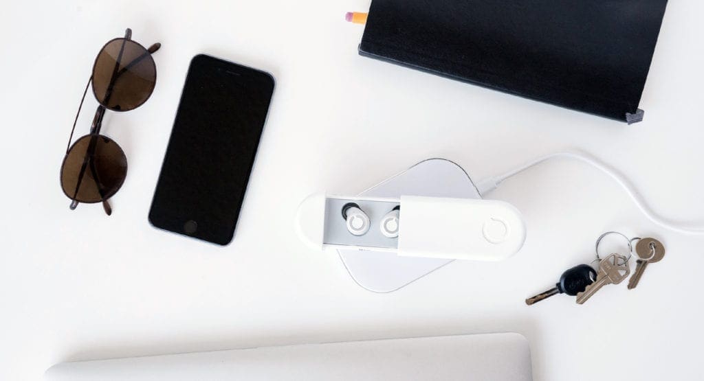 Cue wireless headphones next to daily essentials