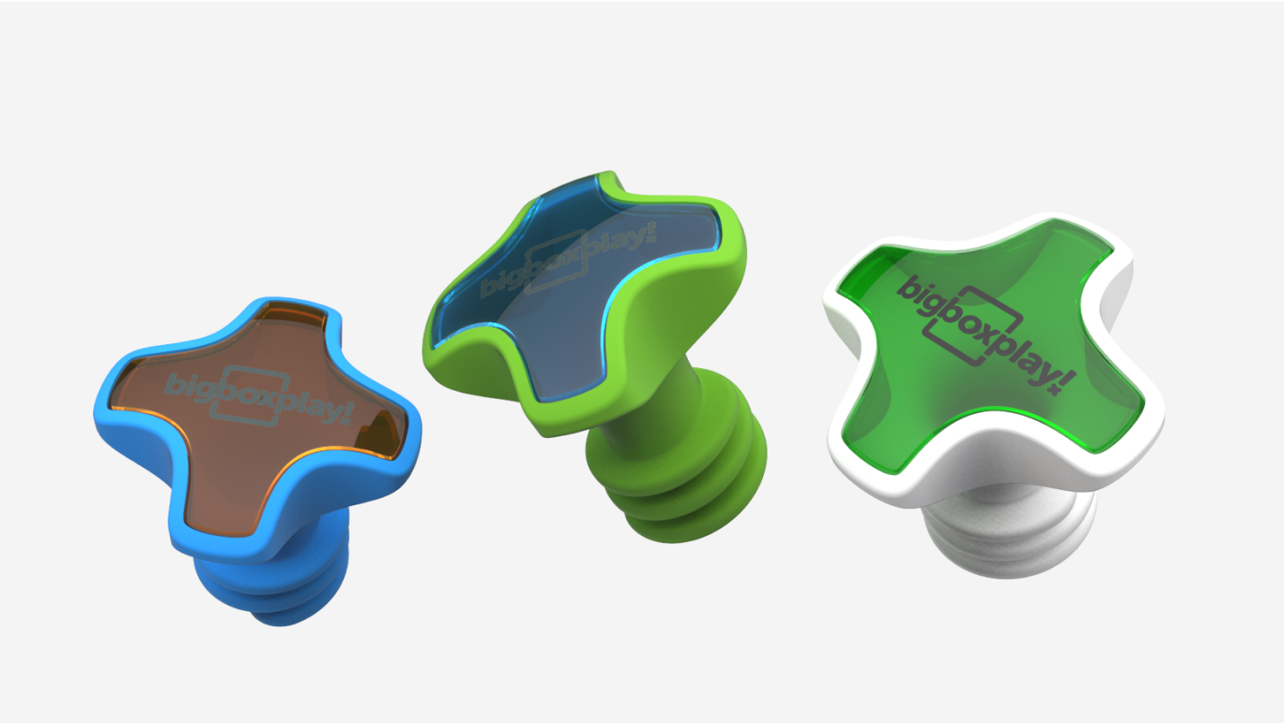 Three cross-shaped bigboxplay pieces in blue, green and white on a light grey background