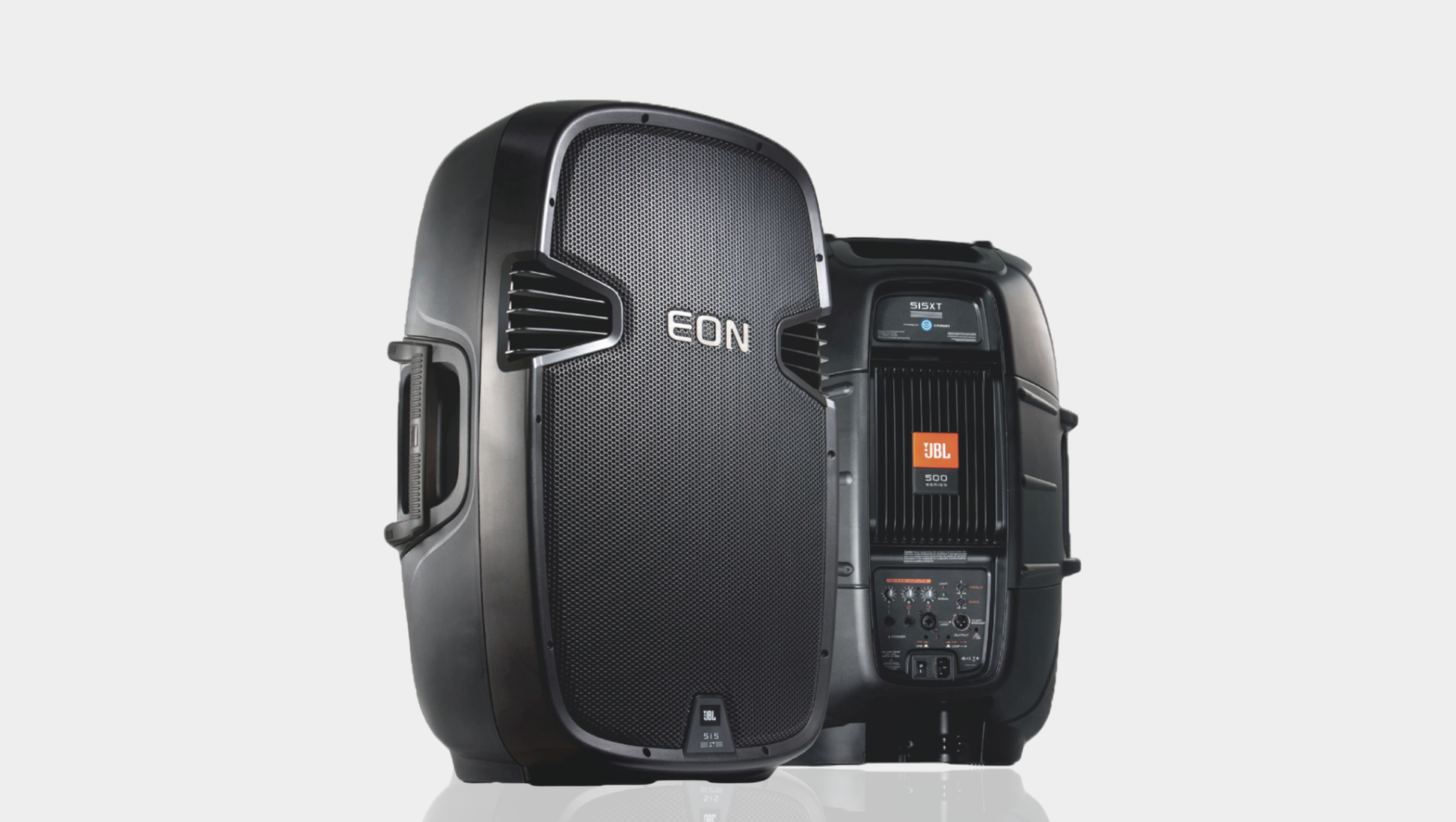 Two black JBL EON 515XT powered speakers shown from the front and the back