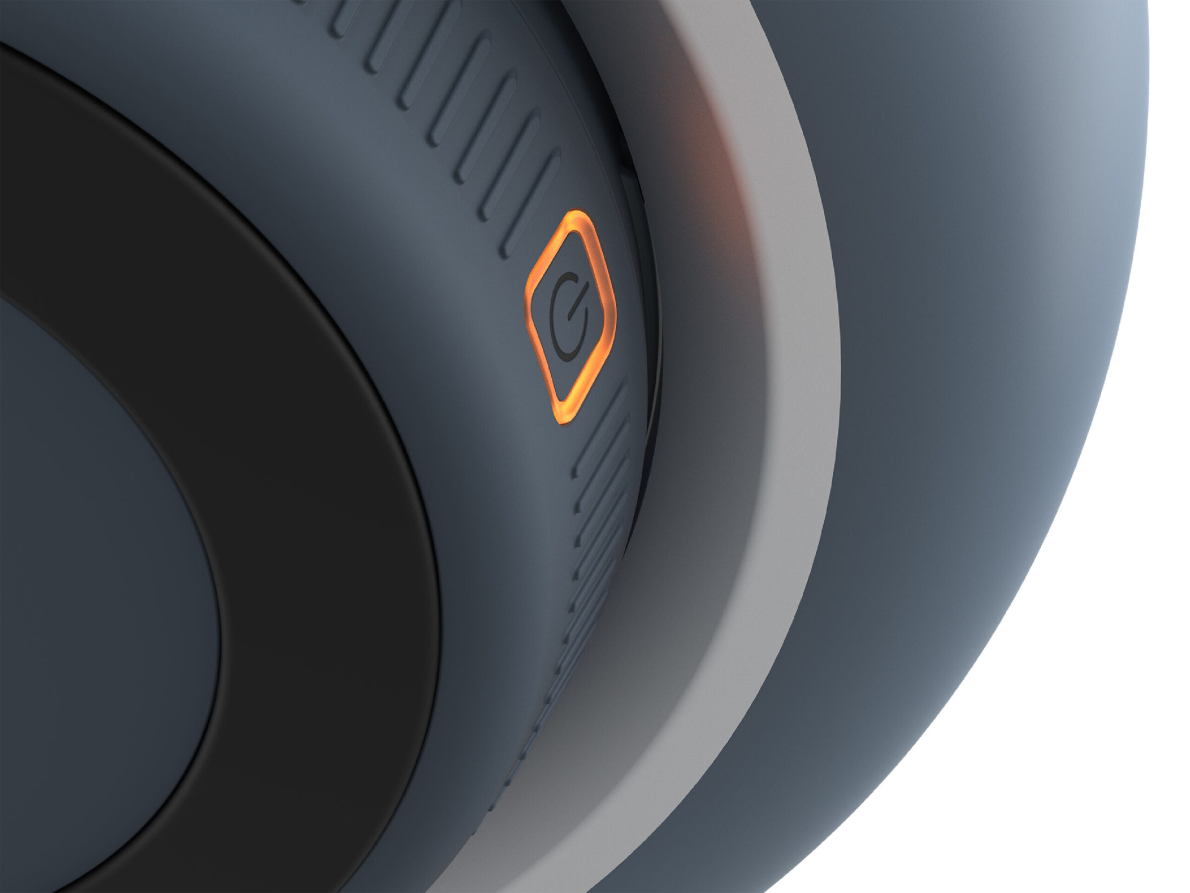 Close-up of a modern, dark gray electronic device with an illuminated orange power…