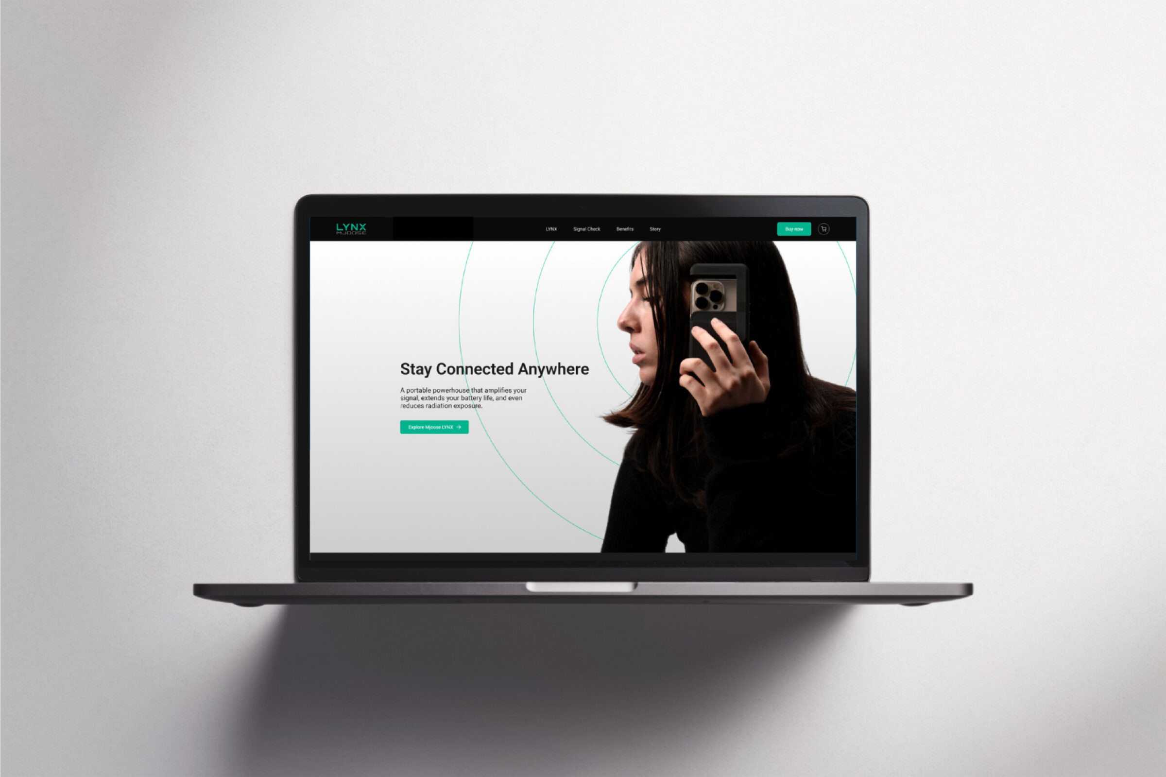 A laptop displaying the LYNX website with a photo of a woman holding a phone.