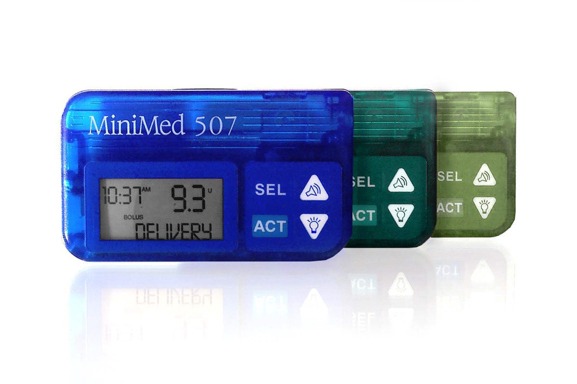 Three MiniMed 507 insulin pump devices in blue, teal, and green are shown overlapping, with digital screens displaying time, dose, and DELIVERY, alongside buttons labeled SEL and ACT.