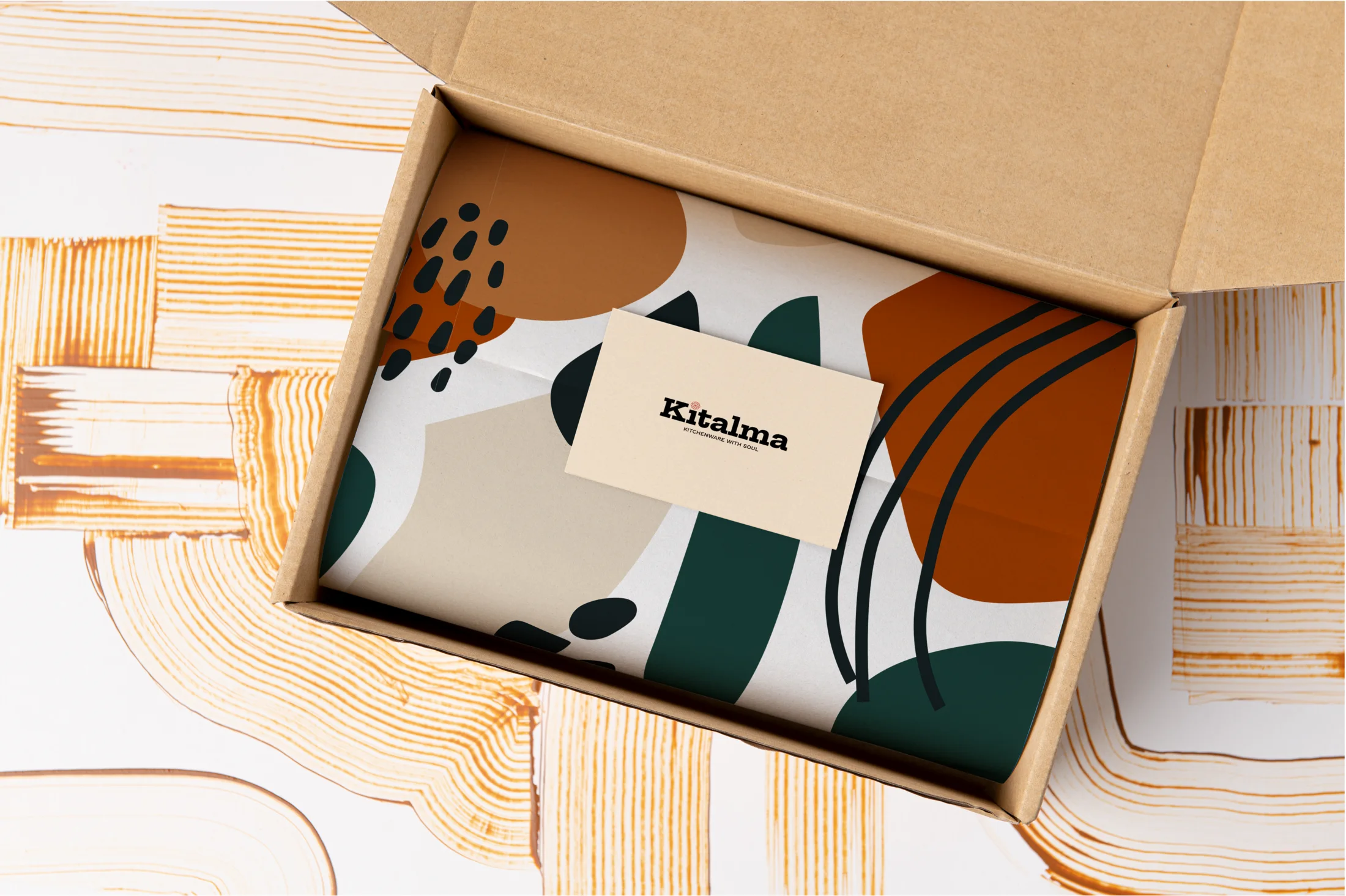An open Kitalma shipping box with a patterned liner and a Kitalma card.