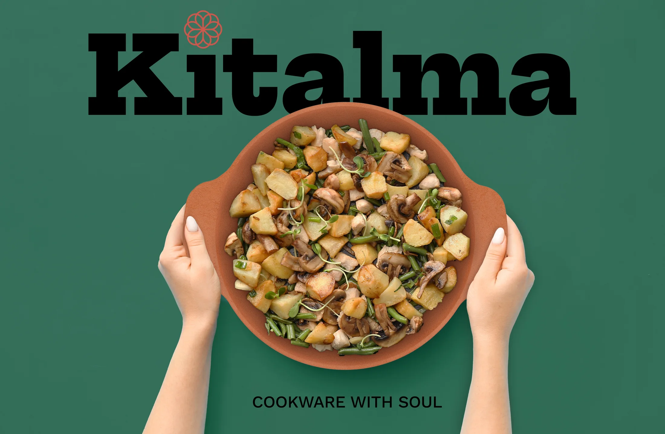 Hands holding a Kitalma clay pot of roasted vegetables on a green background, under the Kitalma wordmark and the line Cookware with soul.
