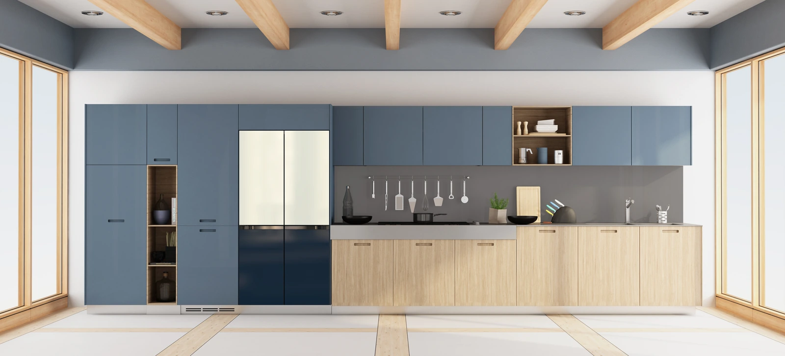 A long open kitchen with blue cabinetry and a two-tone navy and cream Samsung Bespoke refrigerator.