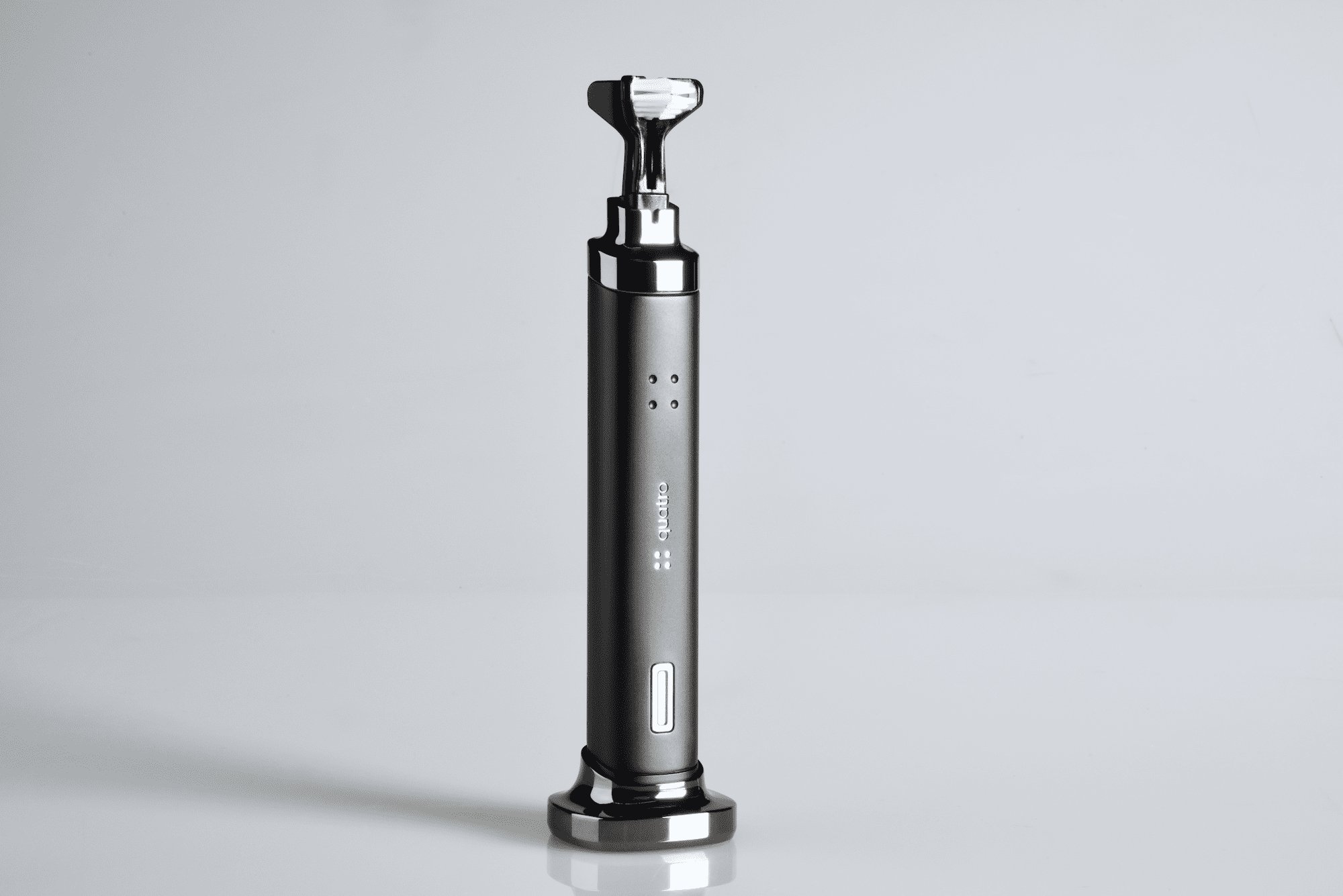 Quatro toothbrush in upright position with dual bristle head and matte finish on white background