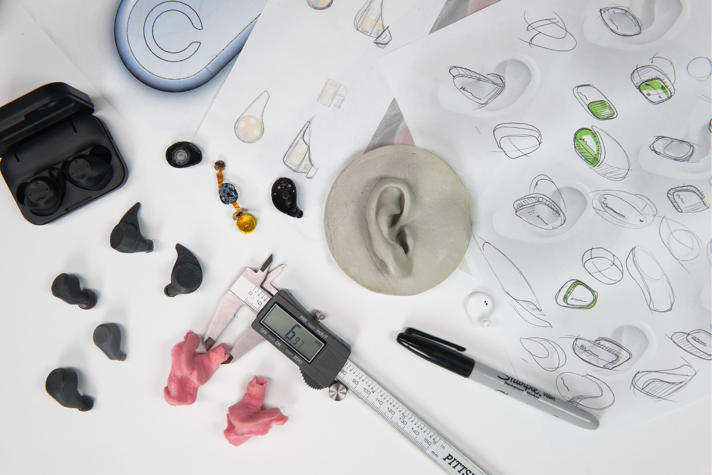 View of RKS Consumer Product Design Conceptualizing Cue Ear Buds with sketches and prototypes