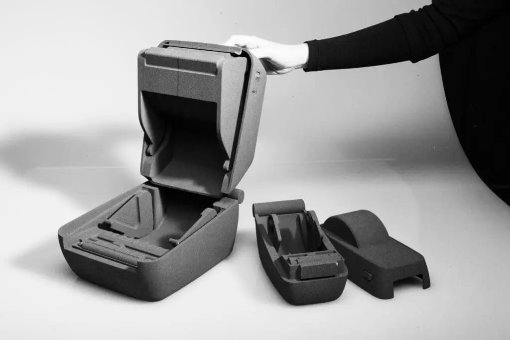 Prototype enclosure with CMF considerations being held open to reveal compartmentalized interior.