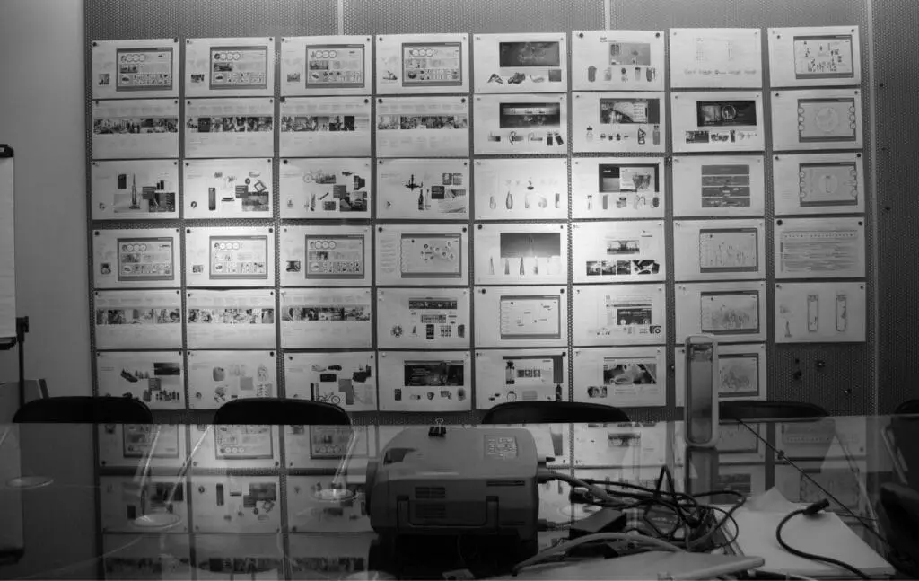 A wall in a conference room at RKS Design filled with research images for the Kor One Water Bottle Project