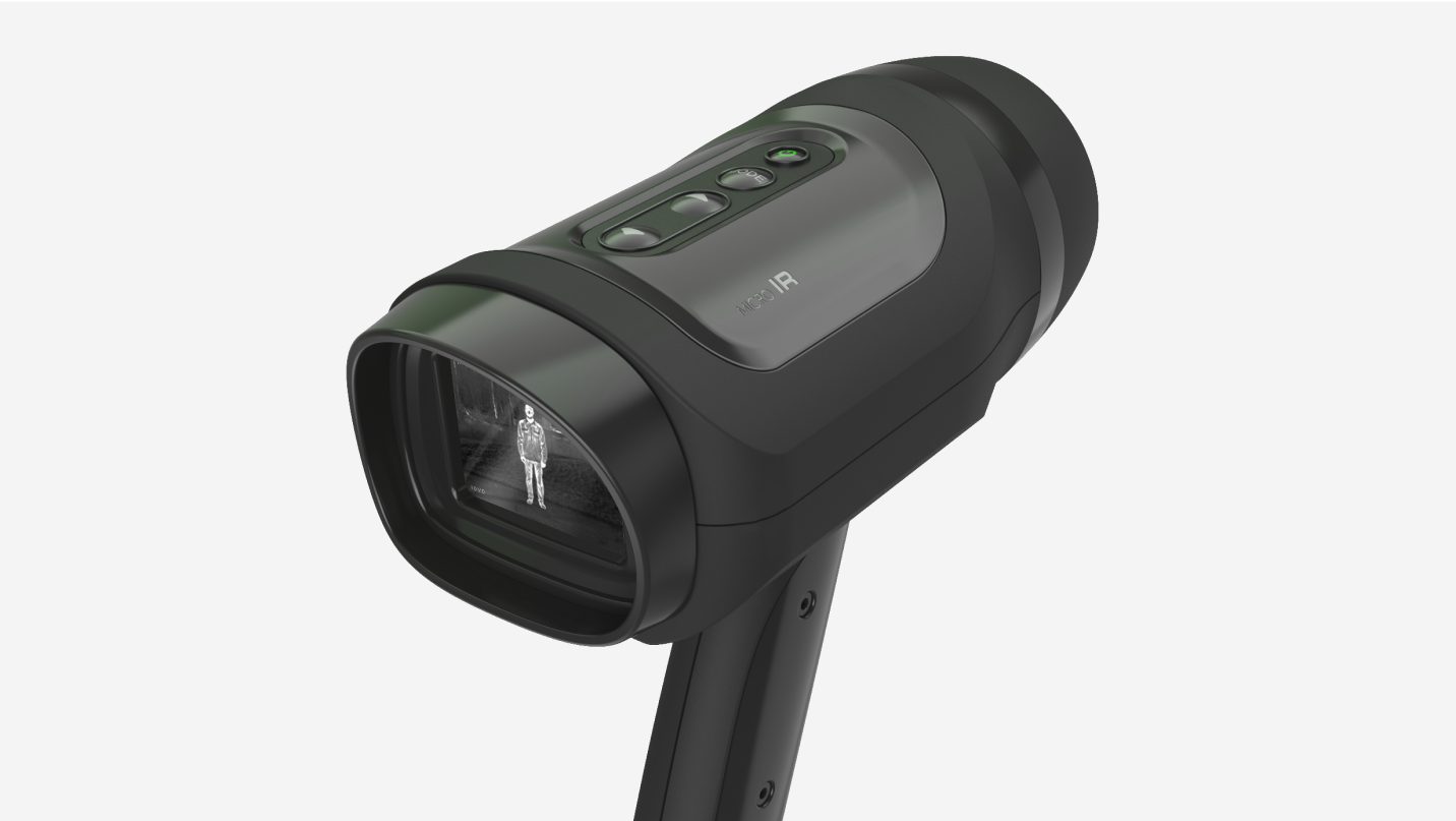 A handheld black thermal imaging device, crafted by a leading Product Design Firm, displays a human figure on its screen and features several buttons alongside a comfortable grip handle.