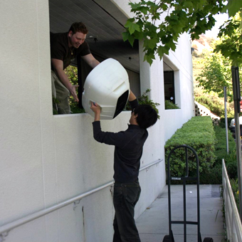 Team testing the portability of a JBL EON speaker prototype, carrying it through different scenarios.