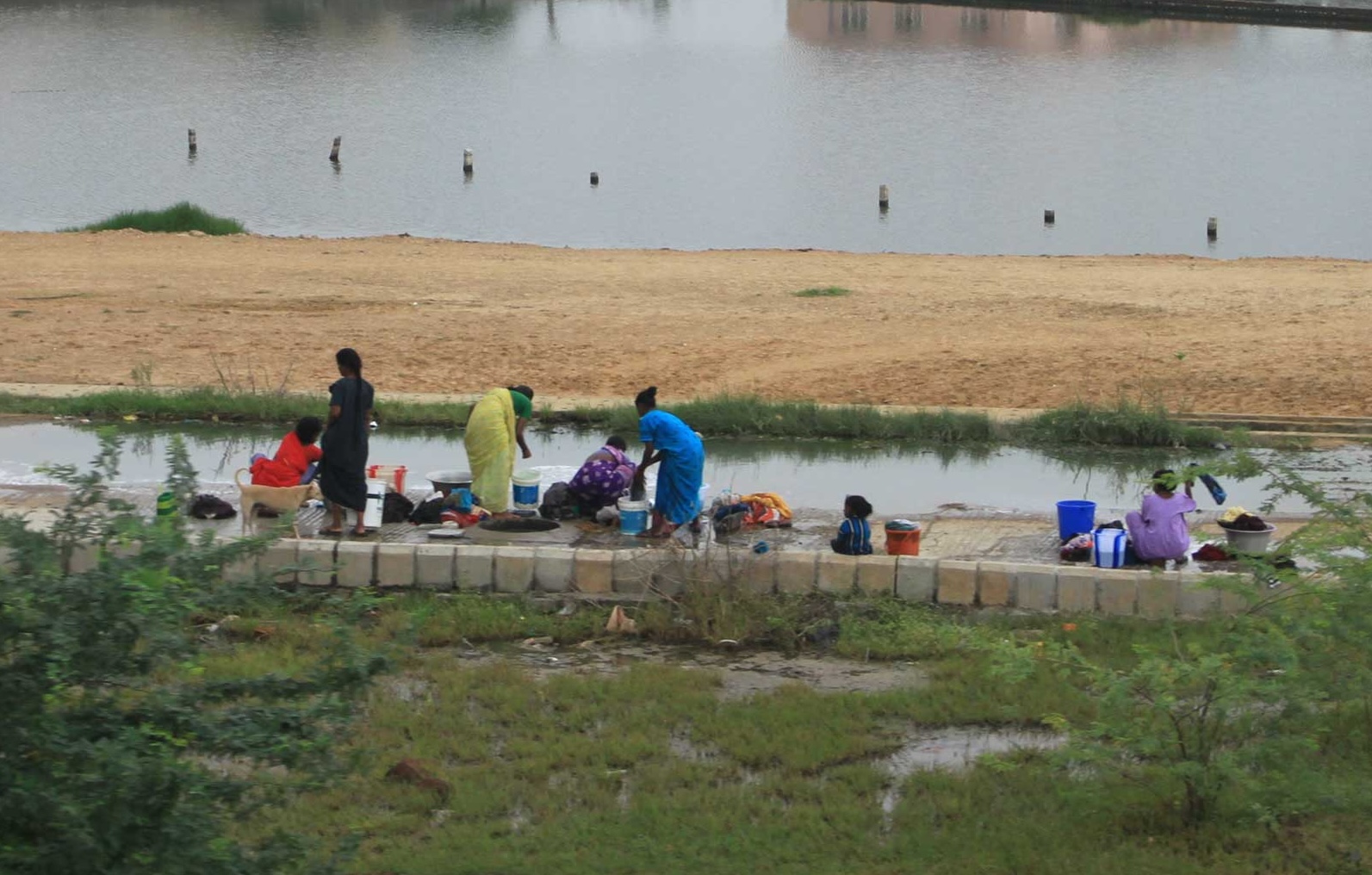 Women washing clothes outdoors, an essential part of RKS Design’s research for Unilever Laundry Additive to address global hygiene needs.