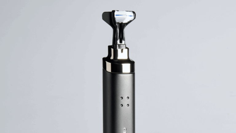Upright smart toothbrush in sleek matte black finish with compact, dual-sided brush head