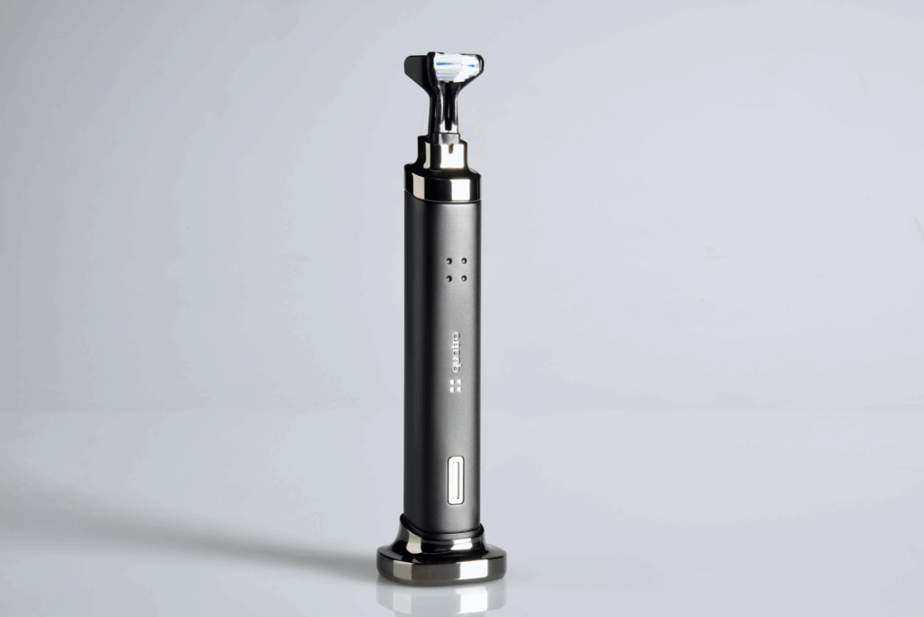 Quatro toothbrush in upright position with dual bristle head and matte finish on white background
