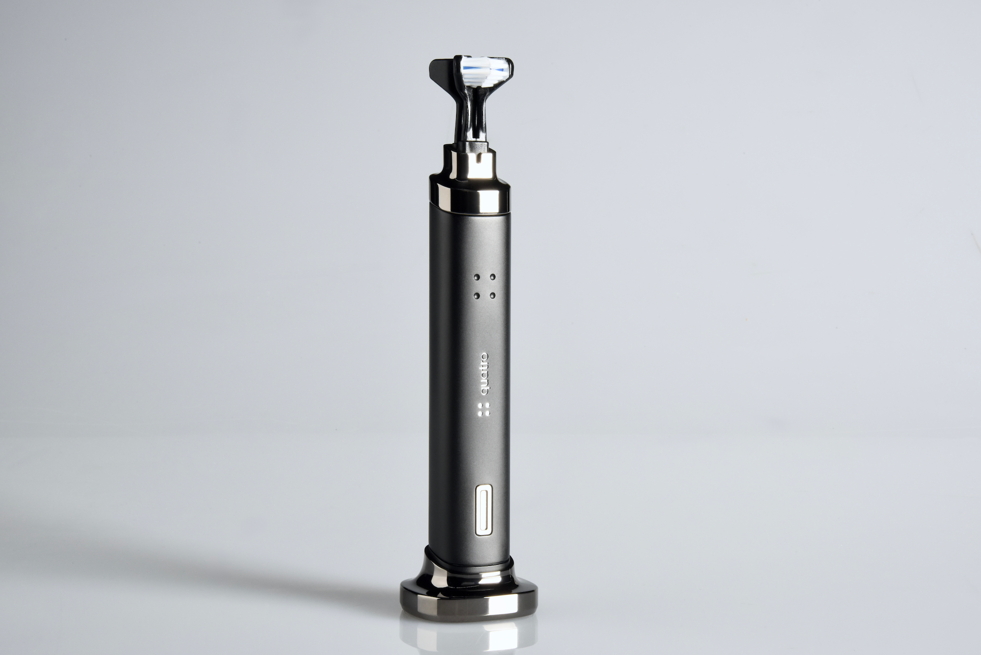 Quatro toothbrush in upright position with dual bristle head and matte finish on white background