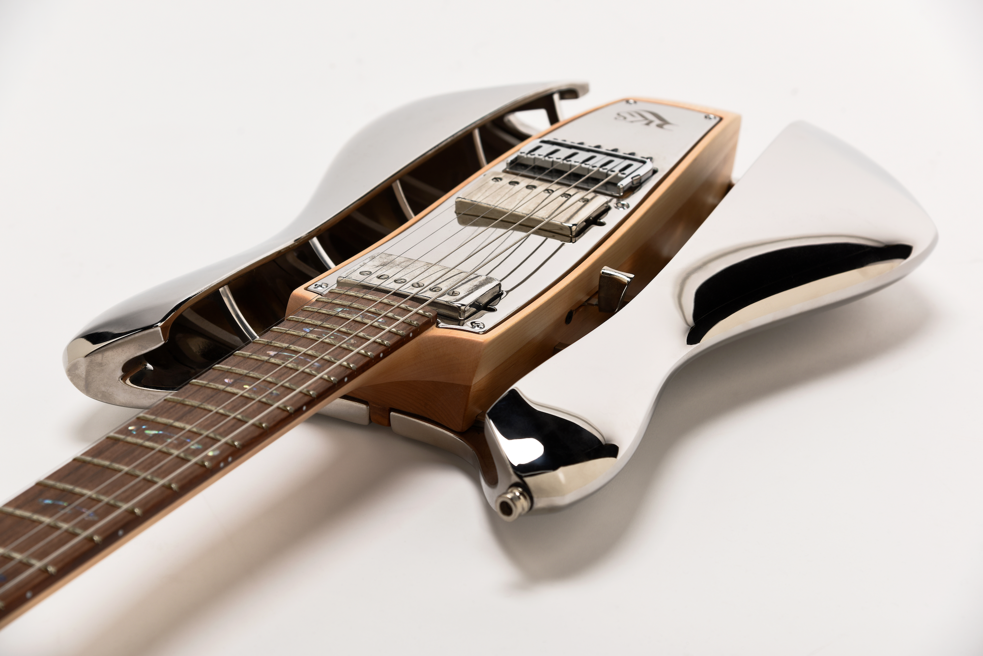 Angled close-up of RKS Guitar neck and body showing chrome side rails and wooden core