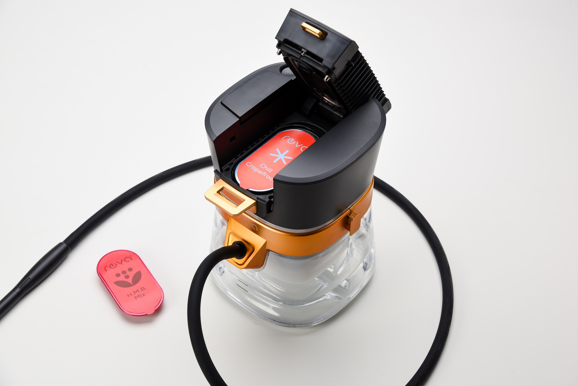 Top view of Reva Hookah with opened lid and visible red Chill Grapefruit flavor capsule beside HMB Mix pod