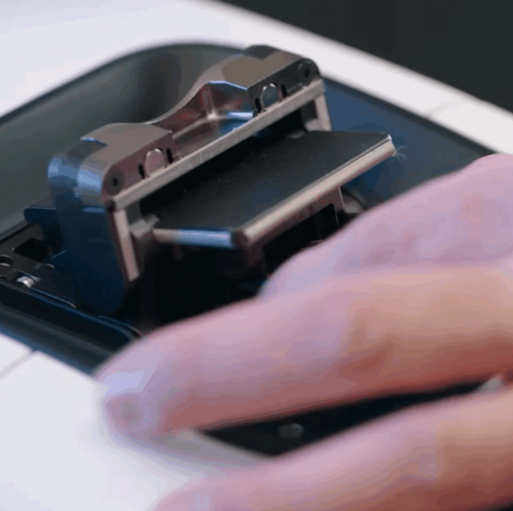 A close-up of a persons hand inserting an ink cartridge into a printer, essential for preparing important documents in the Life Science market.