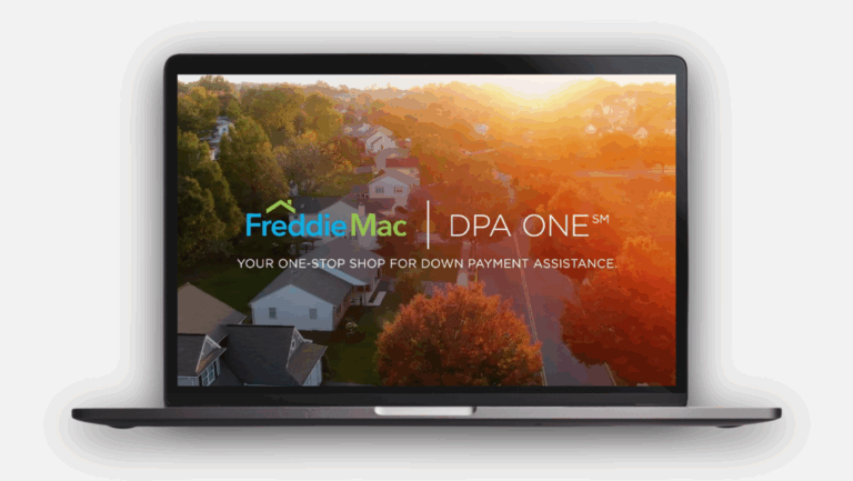A laptop displays an aerial view of a suburban neighborhood at sunset, with the text “Freddie Mac | DPA ONE: Your one-stop shop for down payment assistance” overlaid on the screen.