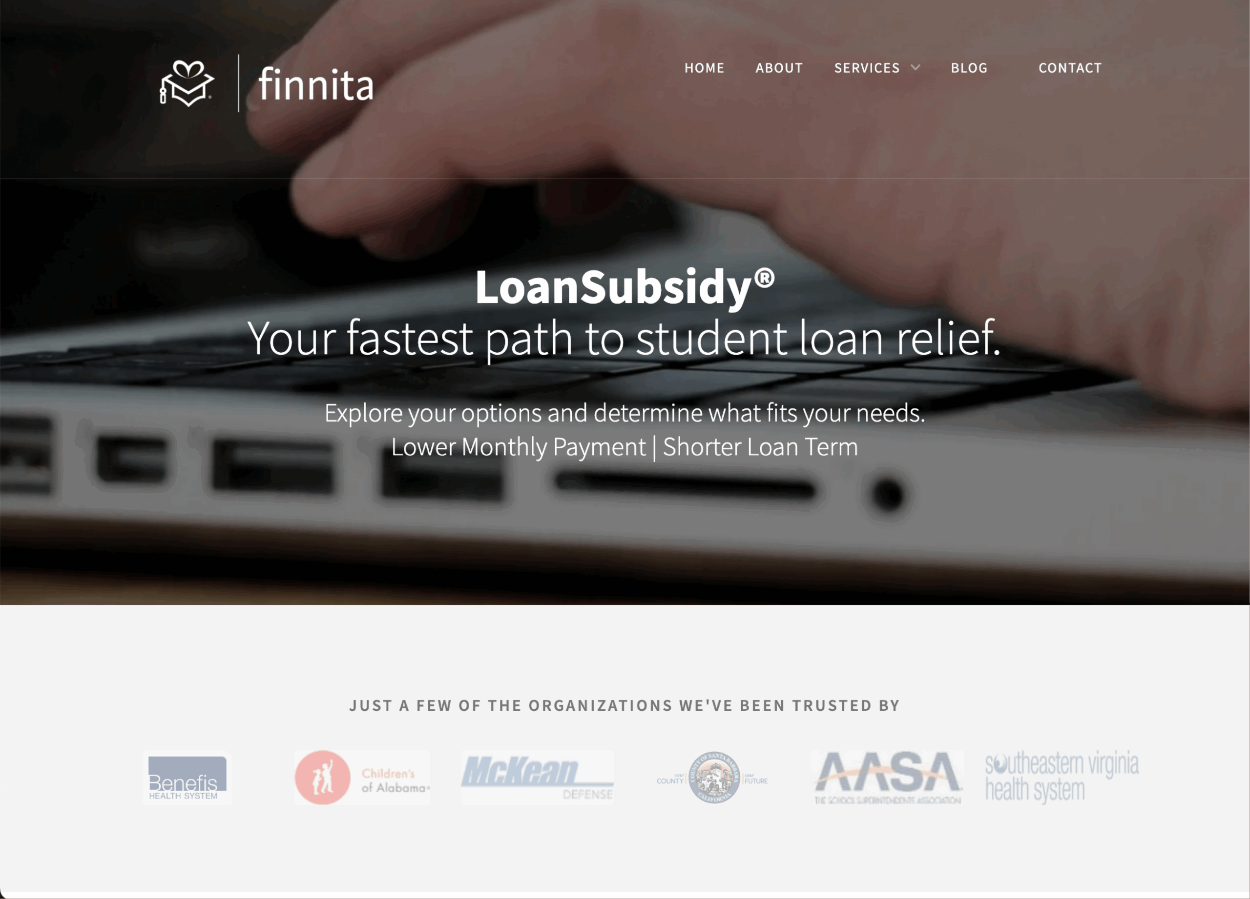 A close-up of a laptop keyboard with the Finnita logo and website navigation at the top. The main text promotes LoanSubsidy, a service for student loan relief. Trusted organization logos are displayed below.