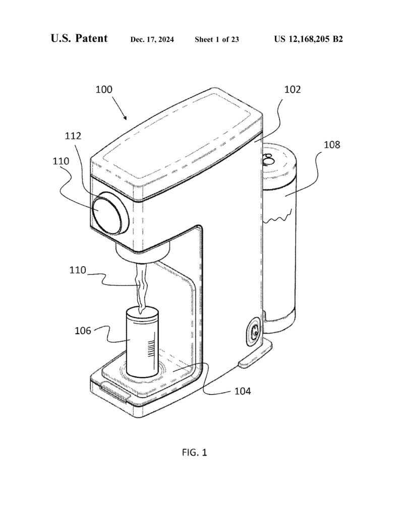 Line drawing of the Baby Barista beverage maker with labeled parts, dispensing liquid into a cup on a tray; a cylindrical container is attached to the side of the machine.