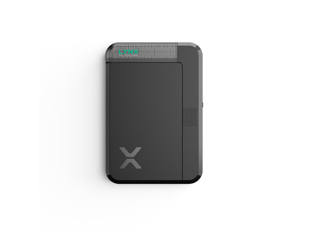 A black rectangular electronic device with a minimalist design, featuring a large X logo near the bottom left and a small patterned section with green indicator lights at the top edge, set against a white background.